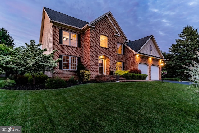 10 Silver Maple Dr, Boiling Springs, PA 17007 - georgian-style home featuring brick siding, a front lawn, driveway, an attached garage, and a shingled roof