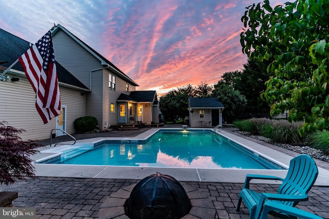 10 Silver Maple Dr, Boiling Springs, PA 17007 - pool at dusk with an outdoor pool, an outdoor fire pit, and a patio area