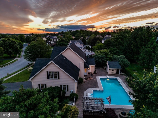 10 Silver Maple Dr, Boiling Springs, PA 17007 - pool at dusk featuring an outdoor structure, an exterior structure, a patio area, and an outdoor pool