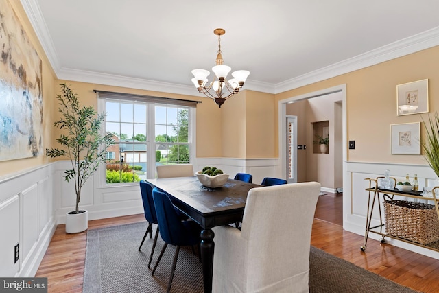 10 Silver Maple Dr, Boiling Springs, PA 17007 - dining space with a chandelier, a wainscoted wall, light wood finished floors, crown molding, and a decorative wall