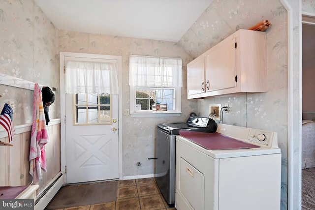 clothes washing area with wallpapered walls, cabinet space, a baseboard radiator, and washer and clothes dryer