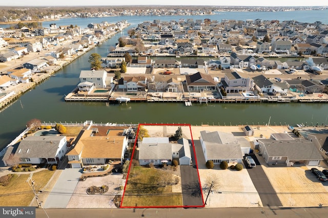 drone / aerial view featuring a residential view and a water view