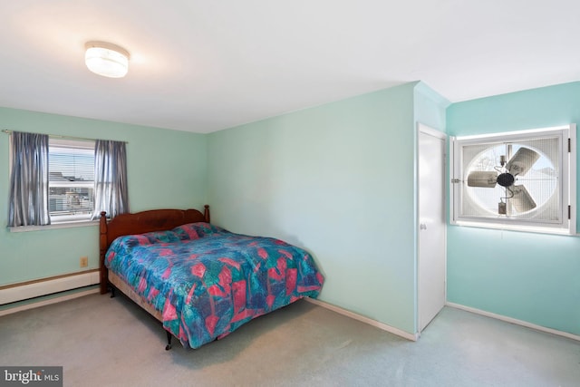 carpeted bedroom with a baseboard radiator and baseboards