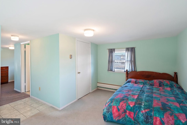 carpeted bedroom featuring a baseboard heating unit, tile patterned floors, and baseboards