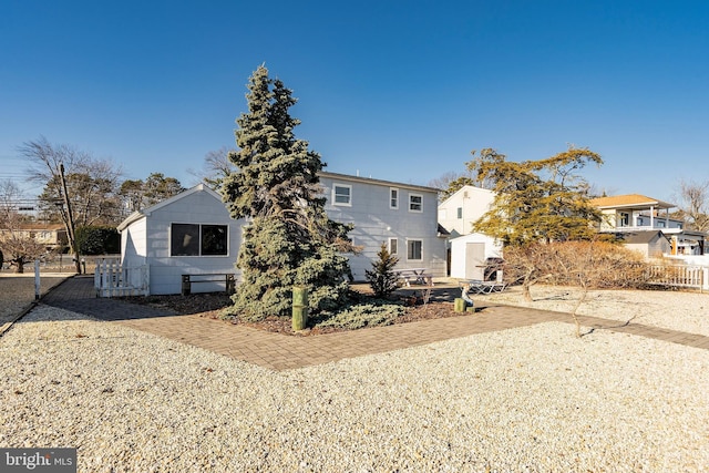 rear view of property featuring an outbuilding and a residential view