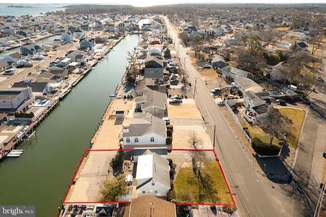 birds eye view of property with a residential view and a water view