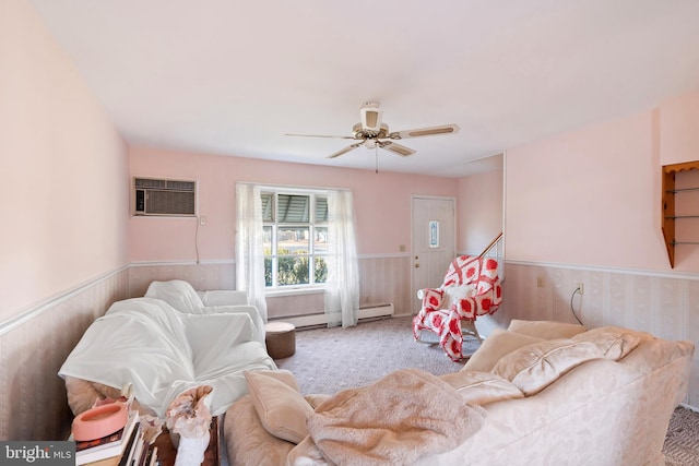 living room featuring an AC wall unit, a ceiling fan, carpet floors, and wainscoting