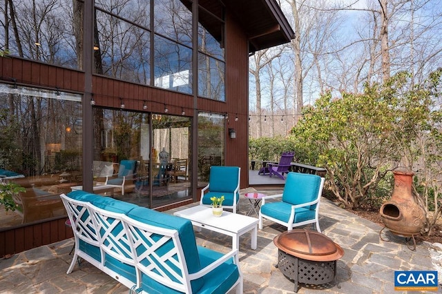 view of patio / terrace featuring a wooden deck and a fire pit