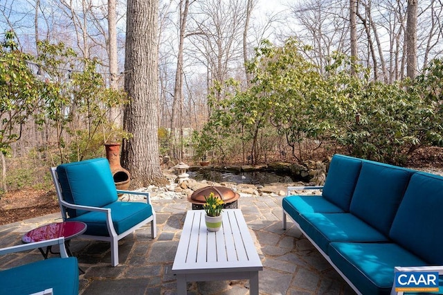 view of patio / terrace with an outdoor living space with a fire pit