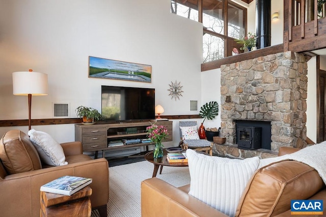 living area with visible vents and a towering ceiling