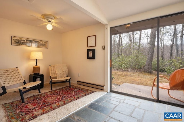 living area with a baseboard heating unit, baseboards, and a ceiling fan