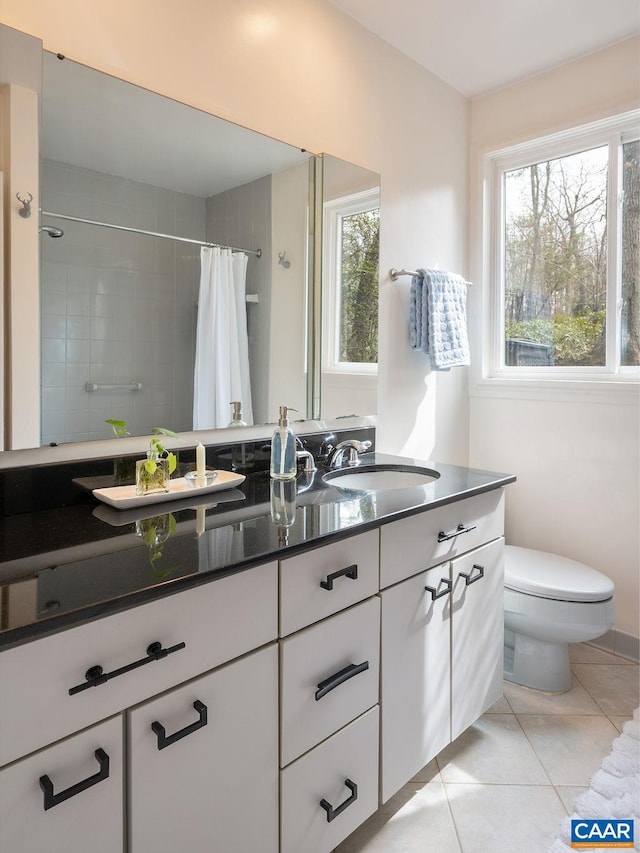 bathroom featuring vanity, tile patterned floors, toilet, and a shower with curtain