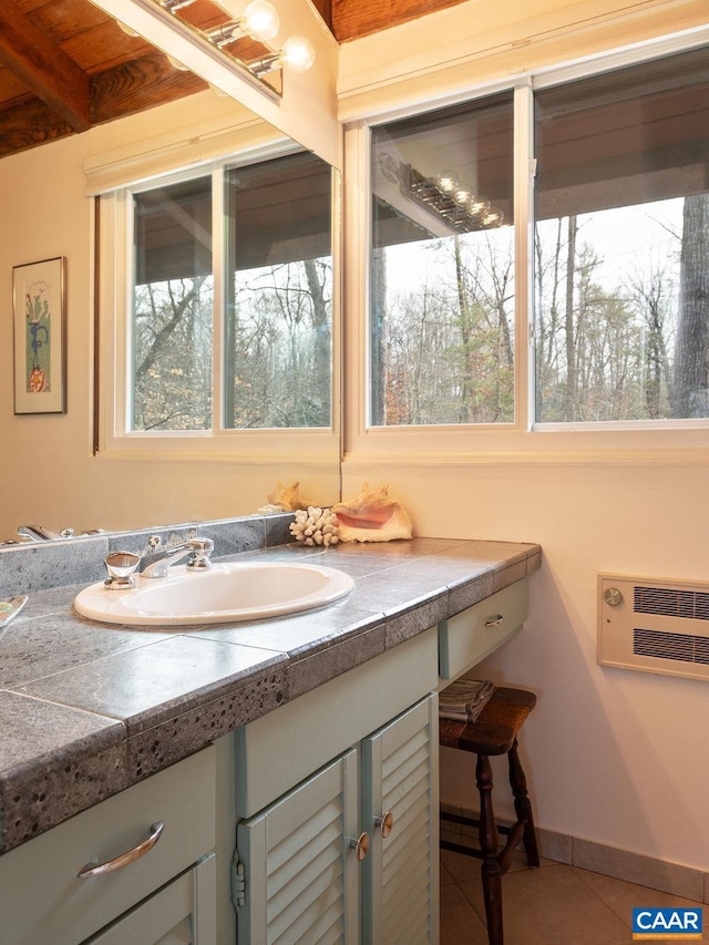 bathroom featuring vanity, an AC wall unit, baseboards, and tile patterned floors