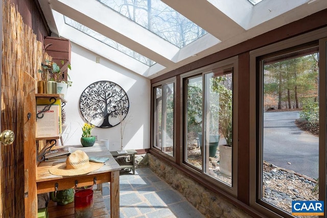 sunroom with vaulted ceiling with skylight