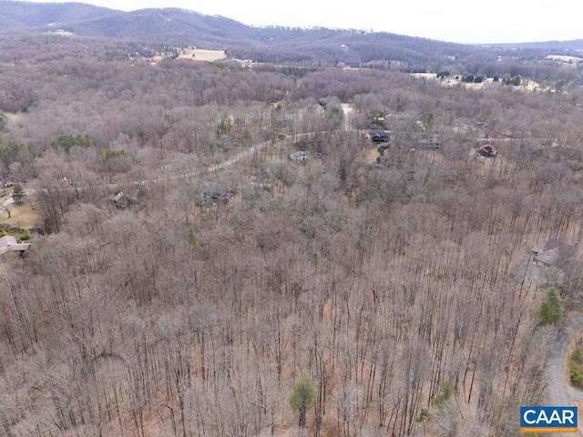 aerial view with a wooded view and a mountain view