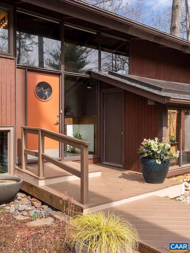 view of exterior entry with a wooden deck