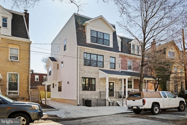 townhome / multi-family property featuring brick siding and a shingled roof