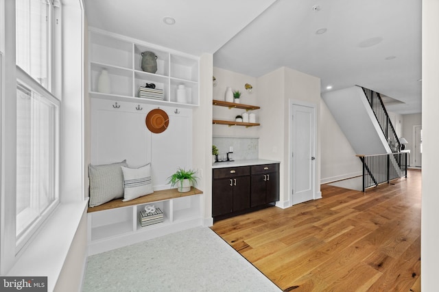 mudroom featuring light wood-style flooring, recessed lighting, and baseboards