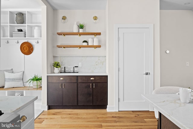 interior space featuring tasteful backsplash and light wood-style flooring