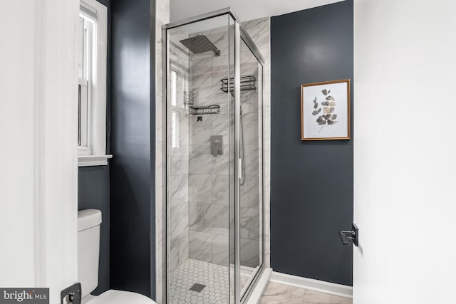 full bathroom with a shower stall, toilet, baseboards, and marble finish floor