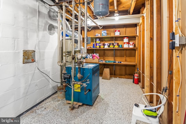 interior space with a heating unit and concrete block wall