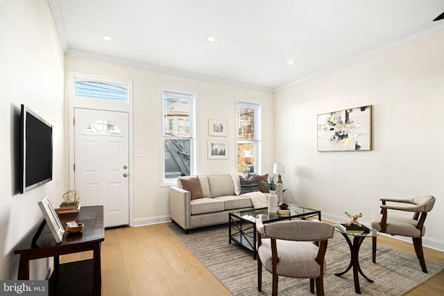 living room with crown molding, recessed lighting, light wood-style floors, and baseboards