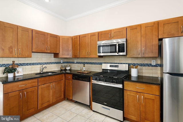 kitchen with a sink, stainless steel appliances, brown cabinets, and ornamental molding