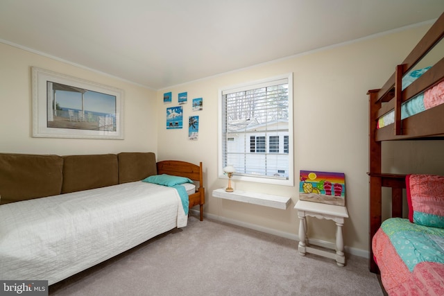 bedroom with light colored carpet, baseboards, and ornamental molding