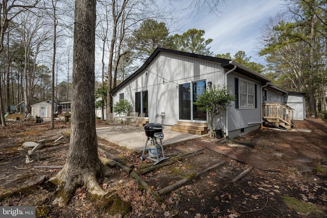 rear view of house featuring crawl space, a patio area, and entry steps