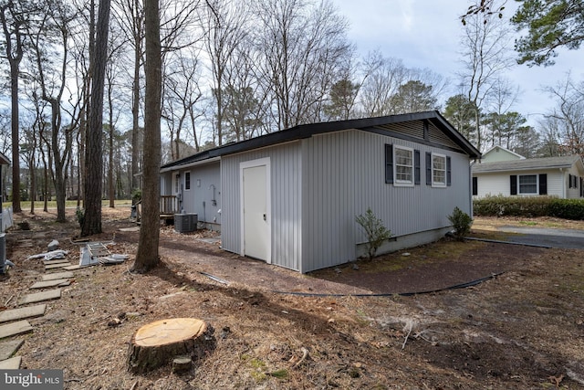 view of home's exterior with crawl space and central air condition unit