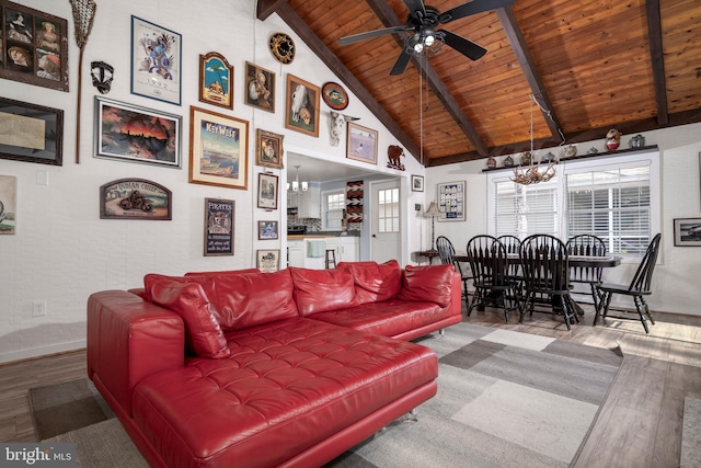 living room featuring wood ceiling, beam ceiling, a healthy amount of sunlight, and wood finished floors