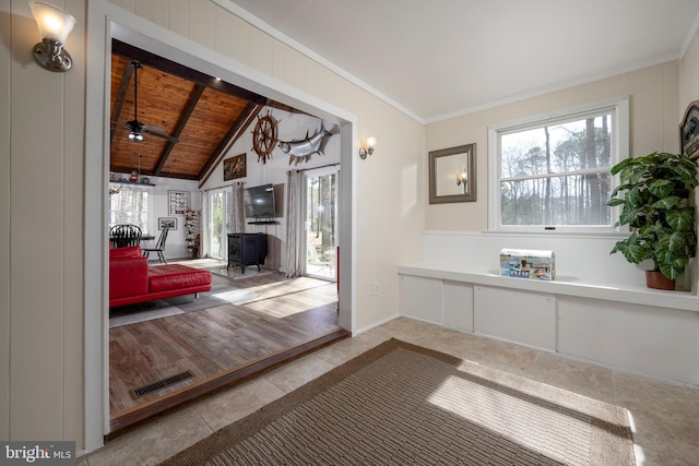 interior space featuring visible vents, wood ceiling, vaulted ceiling with beams, and crown molding