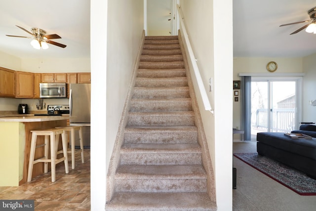 staircase with ceiling fan