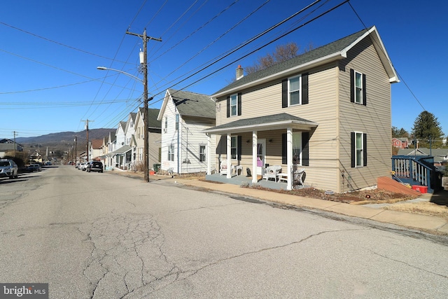 view of front of house with a residential view and a porch