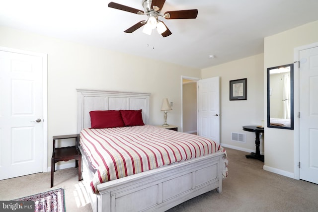 bedroom featuring a ceiling fan, light colored carpet, visible vents, and baseboards