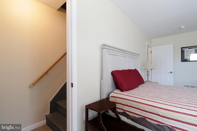 carpeted bedroom featuring visible vents and baseboards