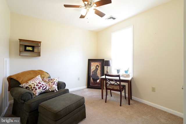 sitting room featuring light carpet, visible vents, ceiling fan, and baseboards