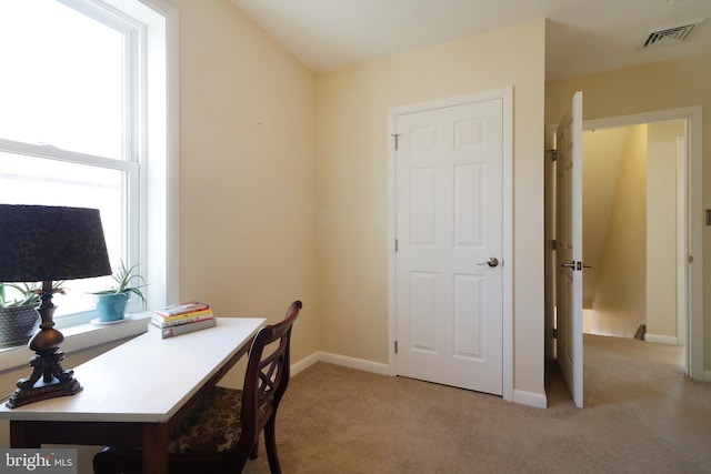 home office featuring visible vents, light carpet, and baseboards