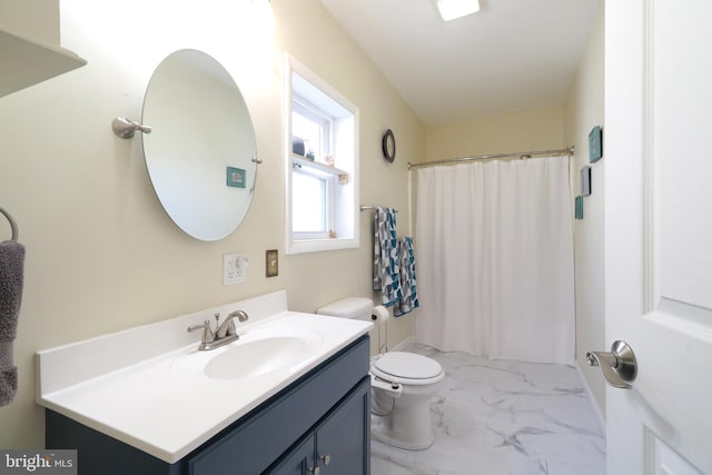 full bath with a shower with curtain, marble finish floor, vanity, and toilet