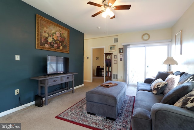 carpeted living room featuring visible vents, baseboards, and a ceiling fan