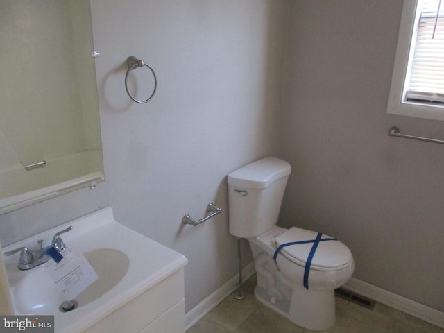 bathroom with tile patterned floors, toilet, vanity, and baseboards