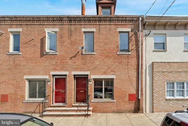 townhome / multi-family property with brick siding