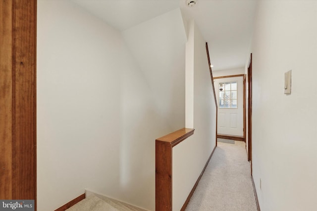 corridor with light carpet and baseboards