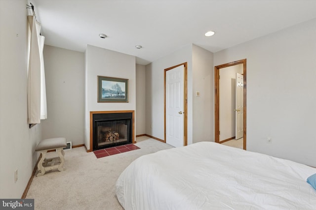 carpeted bedroom with a fireplace with flush hearth, recessed lighting, and baseboards