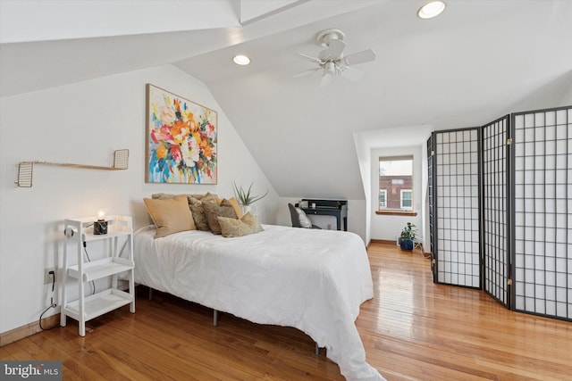 bedroom with lofted ceiling, recessed lighting, baseboards, and light wood finished floors