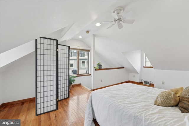 bedroom with recessed lighting, baseboards, lofted ceiling, and wood-type flooring