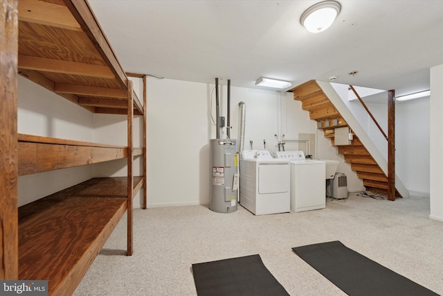 finished basement with stairs, separate washer and dryer, carpet floors, and electric water heater