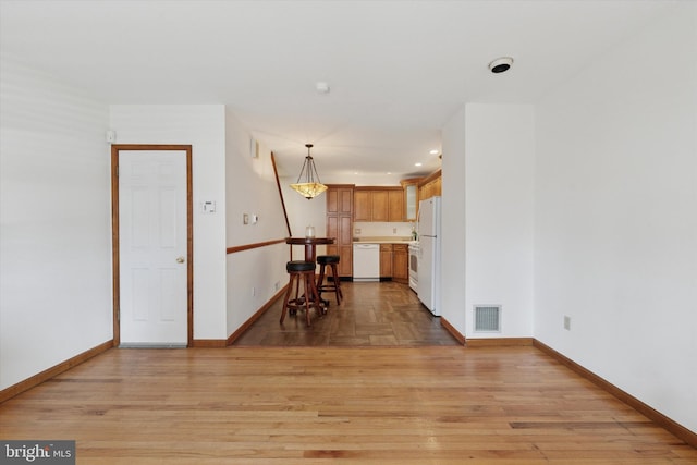 unfurnished living room with light wood-style flooring, recessed lighting, baseboards, and visible vents