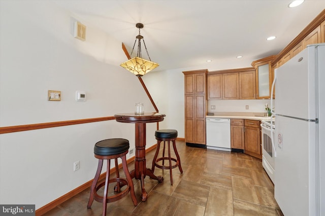 kitchen with white appliances, baseboards, light countertops, glass insert cabinets, and brown cabinets