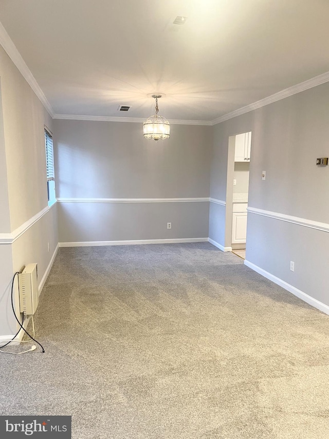 unfurnished room featuring visible vents, ornamental molding, baseboards, and carpet floors